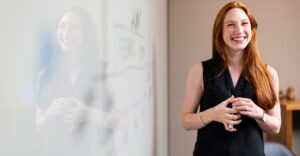 A confident professional presenting in a business setting, highlighting the importance of background screening, including Police Check, to verify employment history and credentials.